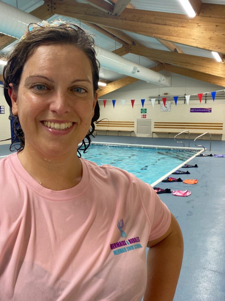 Nadia, founder of Mermaids & Bubbles swim school, smiling by the poolside at Oldway Primary School Pool, Paignton, South Devon